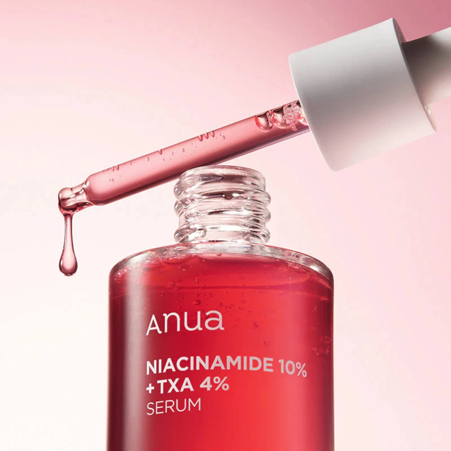 Anua Niacinamide 10% + TXA 4% Serum bottle with dropper on a pink background