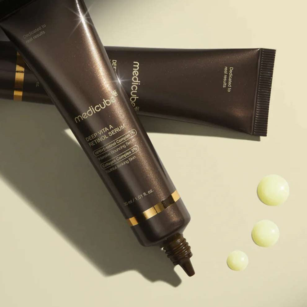 Medicube skincare product with applicator on a beige background