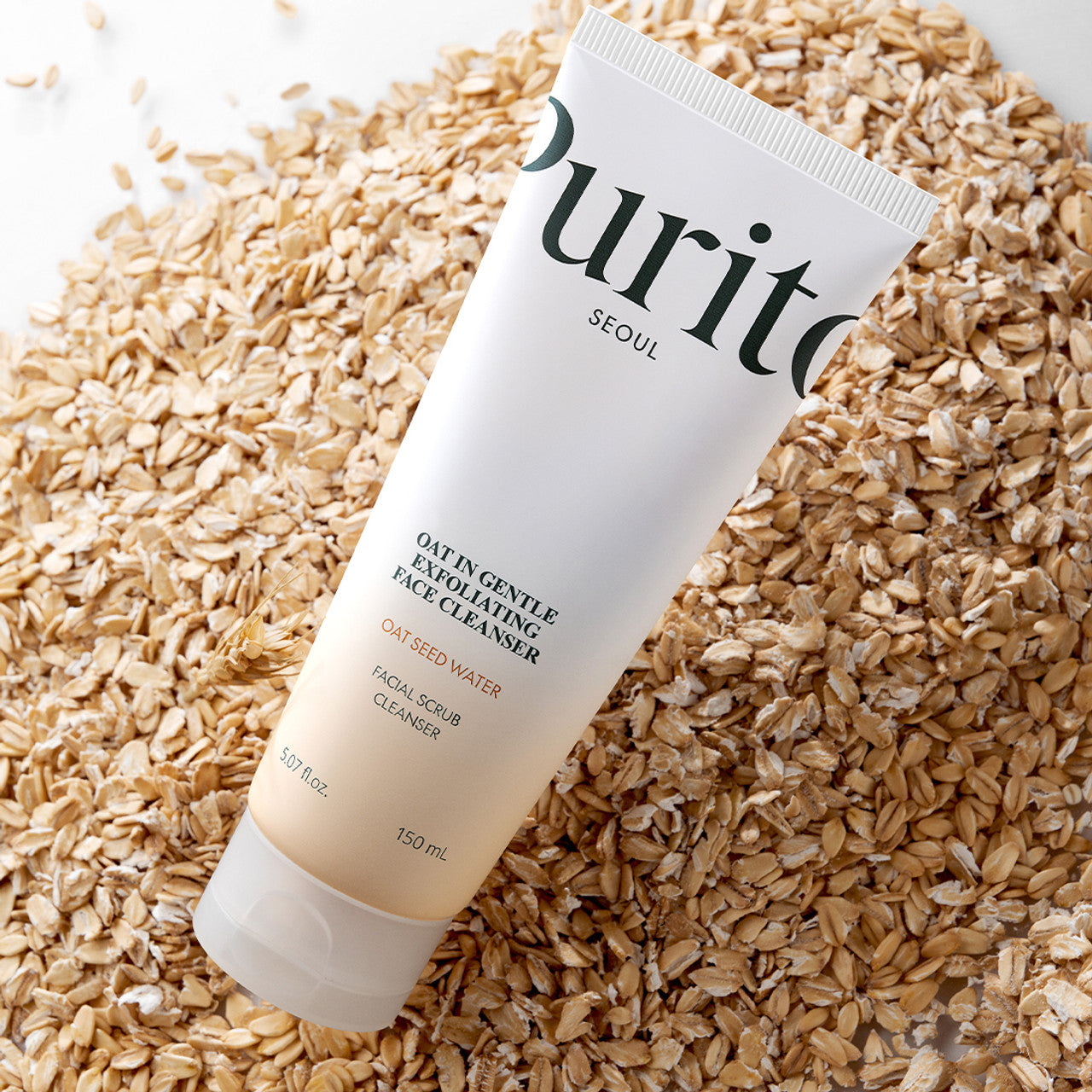 Tube of Purito facial scrub cleaner on a bed of oats