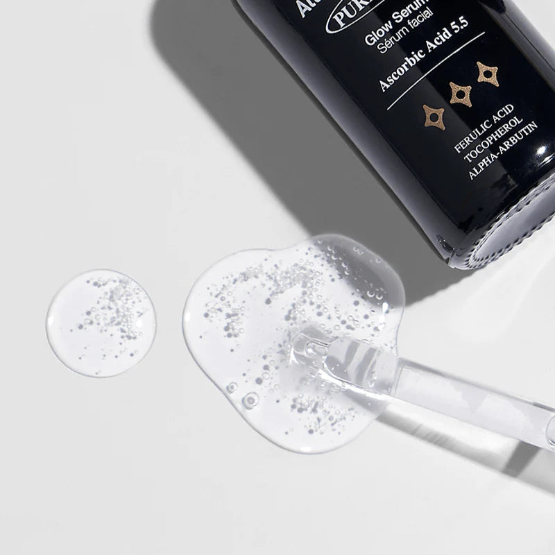 Skincare serum bottle with dropper on a light gray background