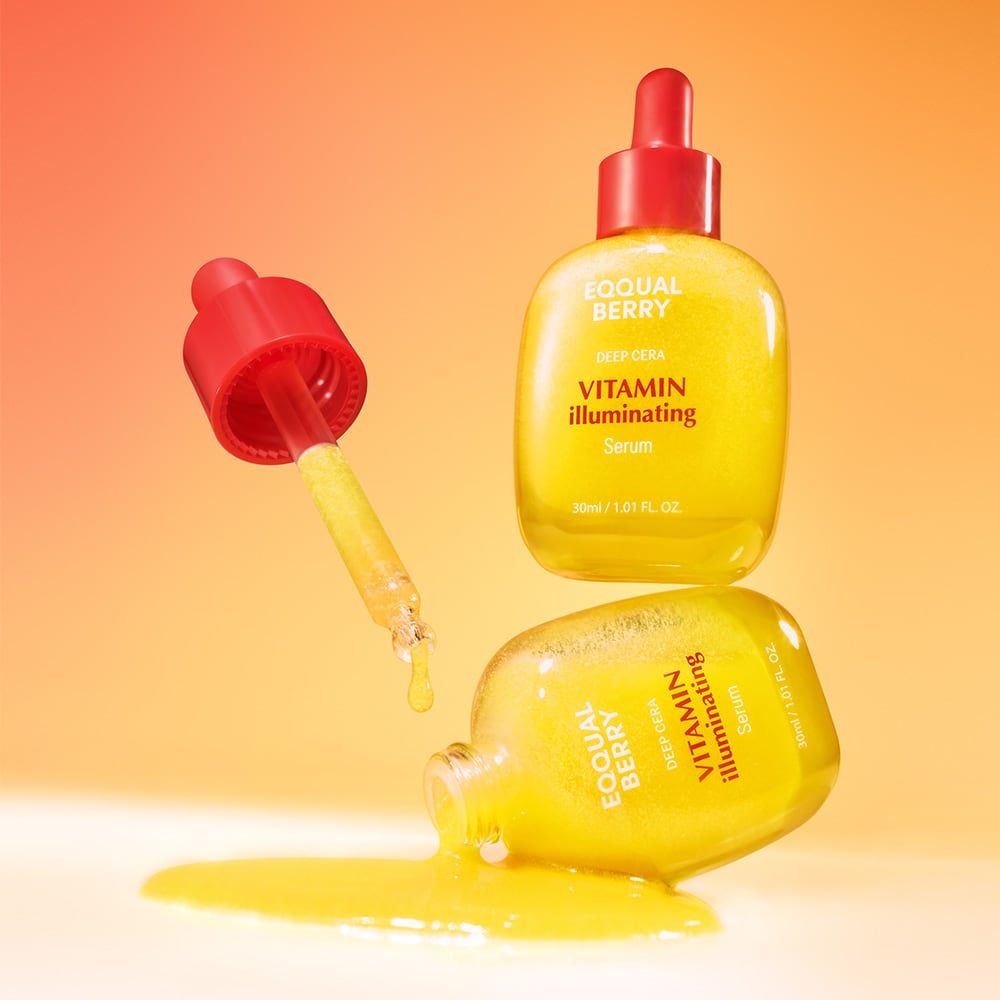 Yellow skincare serum bottle with red cap on an orange gradient background