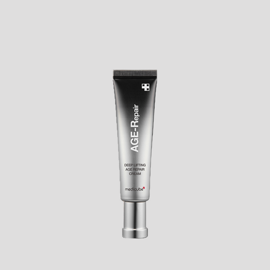 Skincare tube labeled 'AGE-Repair' on a light gray background